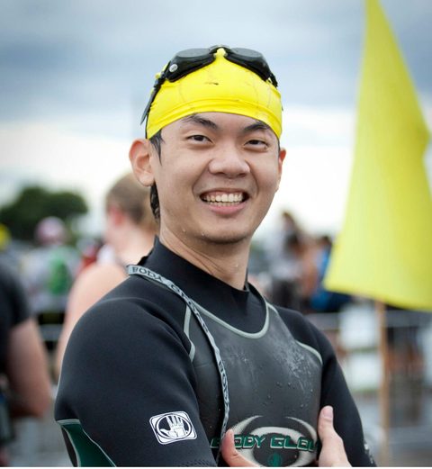 James Kan smiling in a wetsuit and swim cap